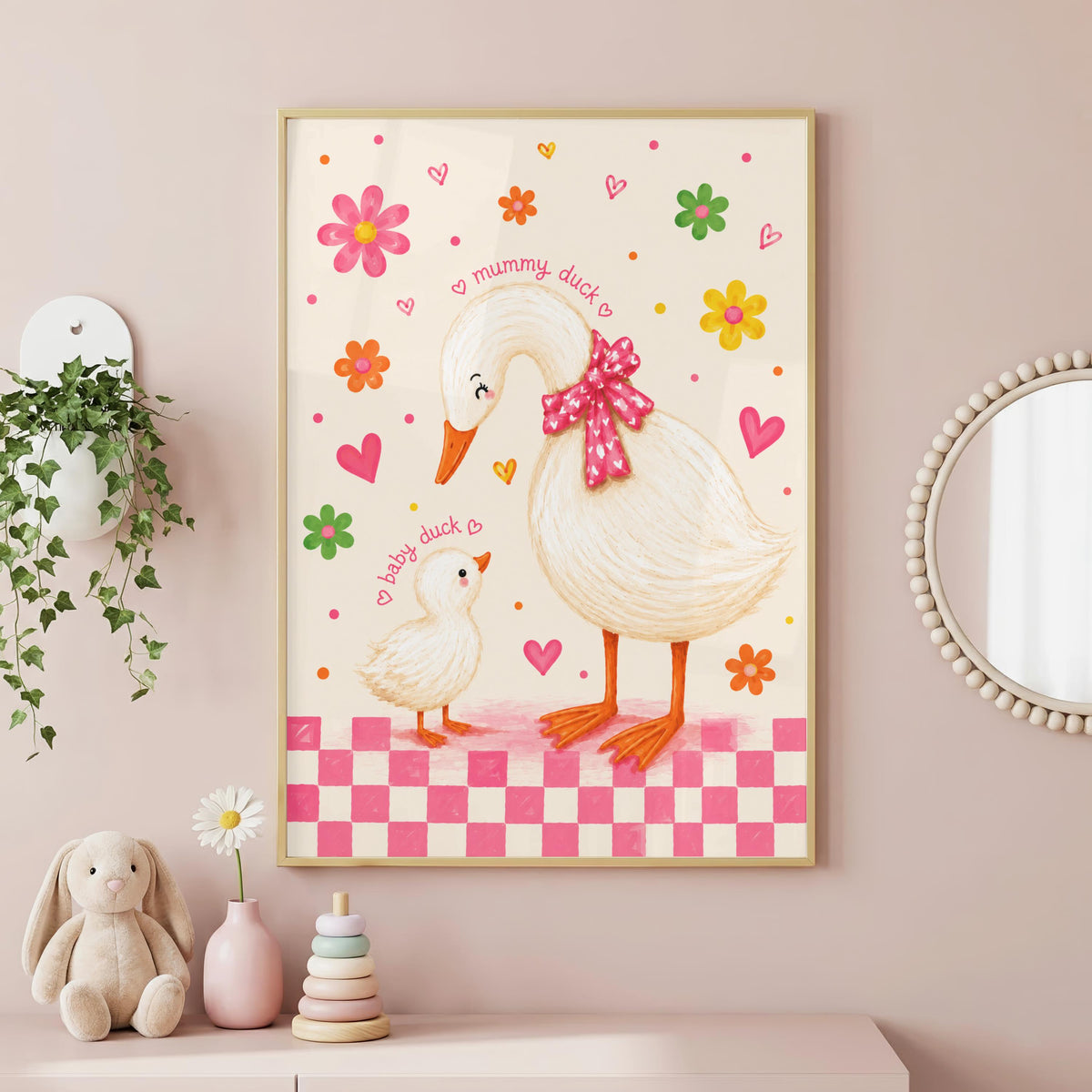 Framed wall art of a large duck and a baby duck in a pink-bordered room with hanging plants and toys.