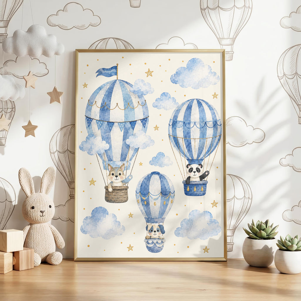 Framed watercolor print showing three blue-striped hot air balloons carrying a puppy, panda, and bunny against a cloudy star background, displayed on a wooden surface with a toy rabbit and potted plants.