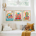 A set of three framed safari animal prints hanging on a white paneled wall above a white daybed filled with pillows and plush toys.