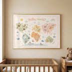 A framed pastel world map with illustrated animals hangs on a beige wall above a wooden crib and a teddy bear.