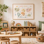 Hello World children’s world map print displayed in a light wood frame in a bright playroom, styled with toy storage, books, globe, wooden toys, rainbow decor, art table, woven baskets and soft neutral furnishings.