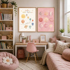 Two matching pink space art prints are displayed above a wooden desk next to a bookshelf and a bed.