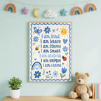 An affirmation poster with blue botanical illustrations hangs above a wooden desk holding a plant and books, with rainbow wall art above.