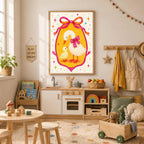 A framed whimsical goose and duckling artwork is centered on a light wall above a child's play kitchen and a table surrounded by toys in a playroom.