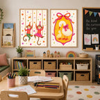 Two framed wall art pieces hang side by side, one showing two monkeys swinging from vines and the other featuring a mother goose and duckling inside a pink arched frame.