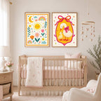 A framed goose and duckling print and a dream big quote print hang on a pink wall above a bed with pink pillows and bedding in a child's bedroom.