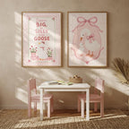 A playroom setting with a small table, pink chairs, and the two goose nursery prints on the wall.