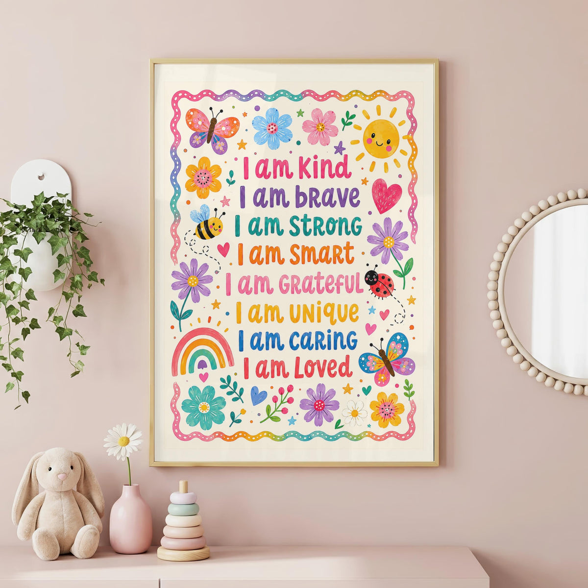 A framed children's affirmation poster hangs on a pink wall above a shelf with a stuffed bunny, a flower vase, and a stacking toy.