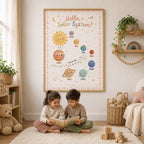 Hello Solar System children’s educational wall print displayed in a light wood frame above two children reading together in a cosy nursery reading corner, styled with soft toys, books, woven baskets, plants and warm neutral decor.