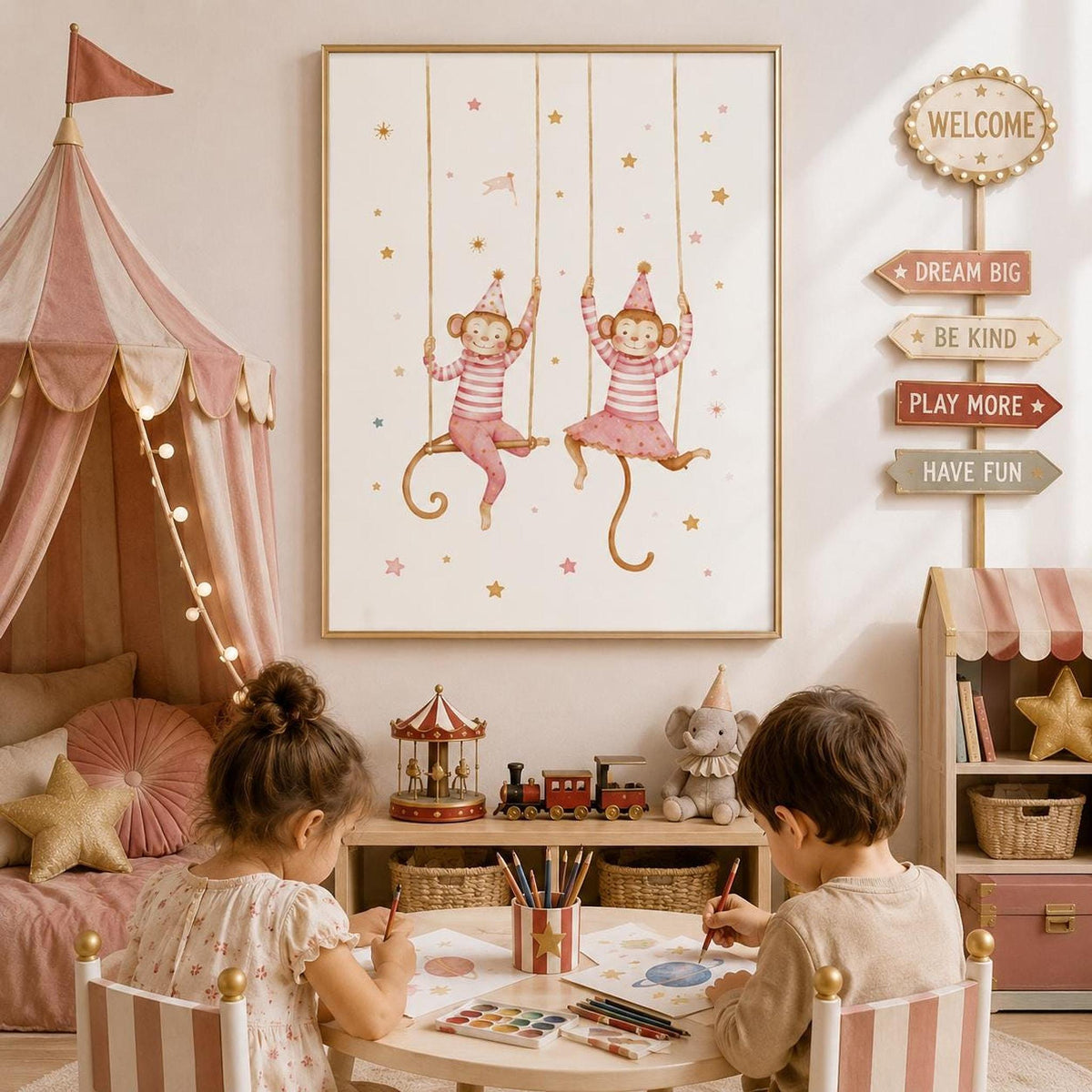Pink circus-themed monkey wall print displayed in a light wood frame in a children’s playroom, styled with a striped circus tent, carousel toy, train, plush elephant, toy storage and two children drawing at a small table.