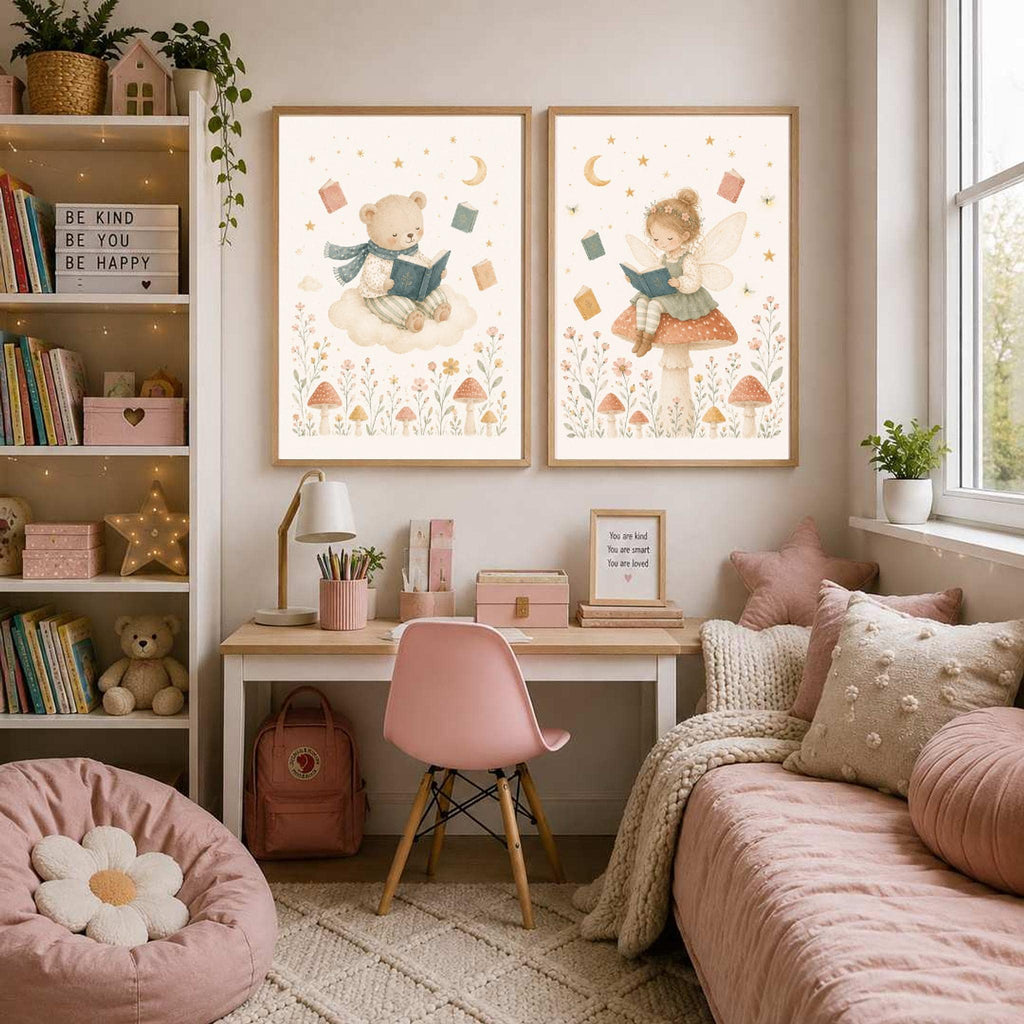 Two framed prints of a bear on a cloud and a fairy on a mushroom hang above a desk in a pink-themed bedroom.