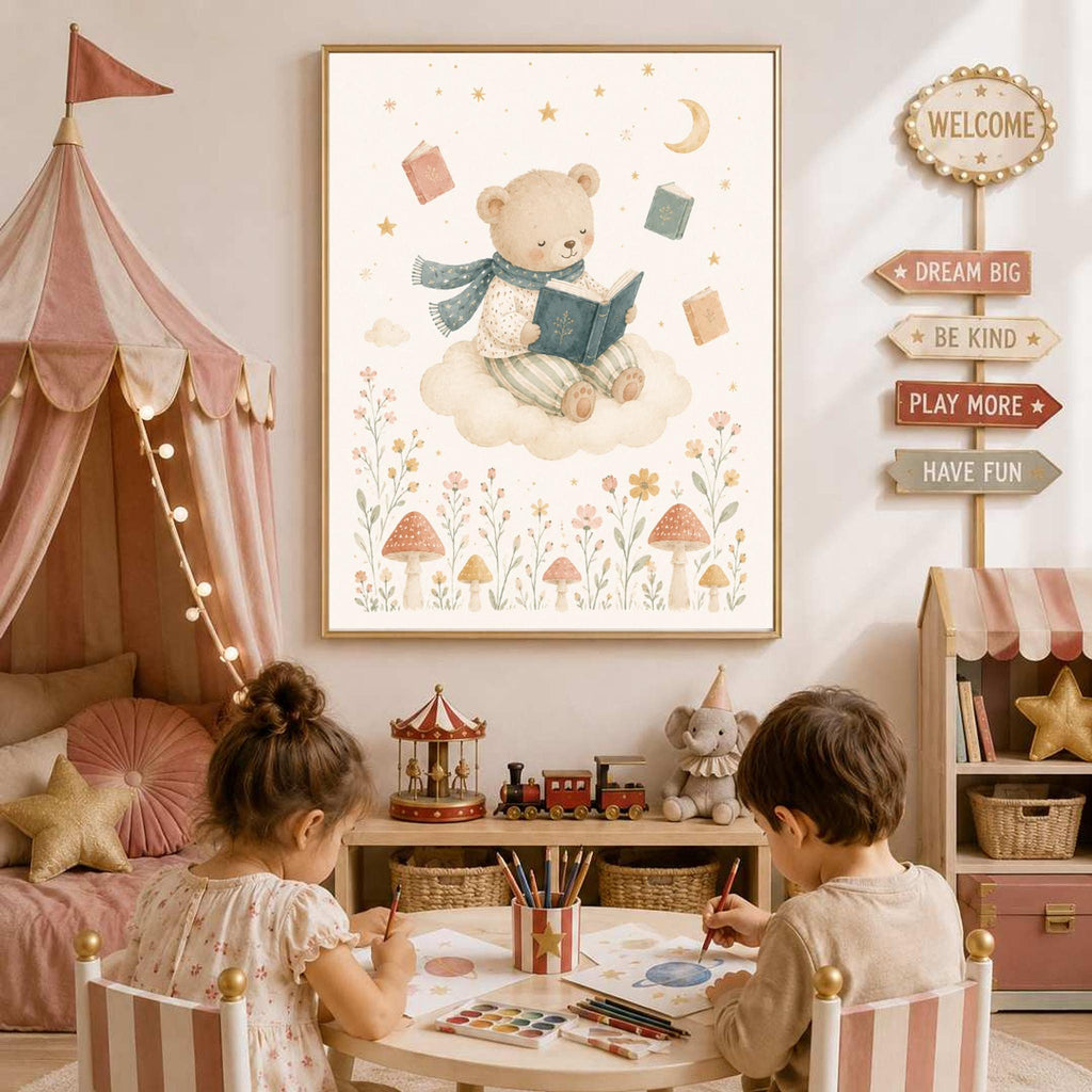 A framed watercolor illustration of a teddy bear reading a book on a cloud hangs on a wall above two children drawing at a small table.