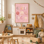 A pink planet print hangs over a child's play kitchen and activity table filled with toys.