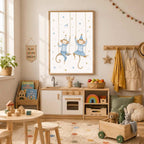 A framed watercolor print of two monkeys on swings hangs on a wall above a child s play kitchen and table.