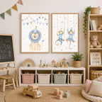 Two framed watercolor prints featuring a lion and swinging monkeys hang side by side above a low white storage unit.