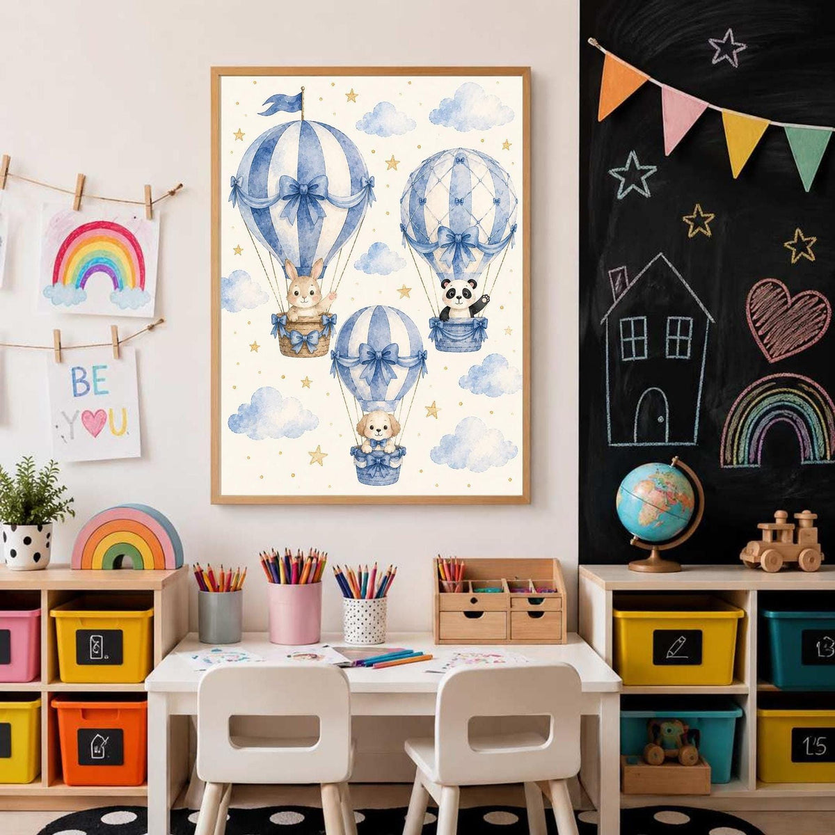 Kid study room with a framed blue hot air balloon poster centered above a white desk, flanked by a chalkboard wall and colorful storage cubbies.