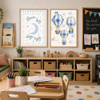 Two framed wall art prints hang above a toy storage unit, one showing blue hot air balloons and the other displaying text that reads sleep tight.