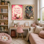Two framed fantasy prints titled Wishes Wonder and Magic and Little Witches Club hanging on a wall above a desk.