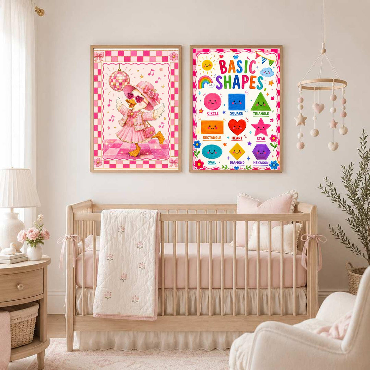 Two framed prints hang on the wall above a wooden baby crib in a nursery room.