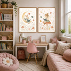 Two framed watercolor prints of a bunny on the moon and a fairy on a mushroom are hung on a wall above a desk and pink daybed.