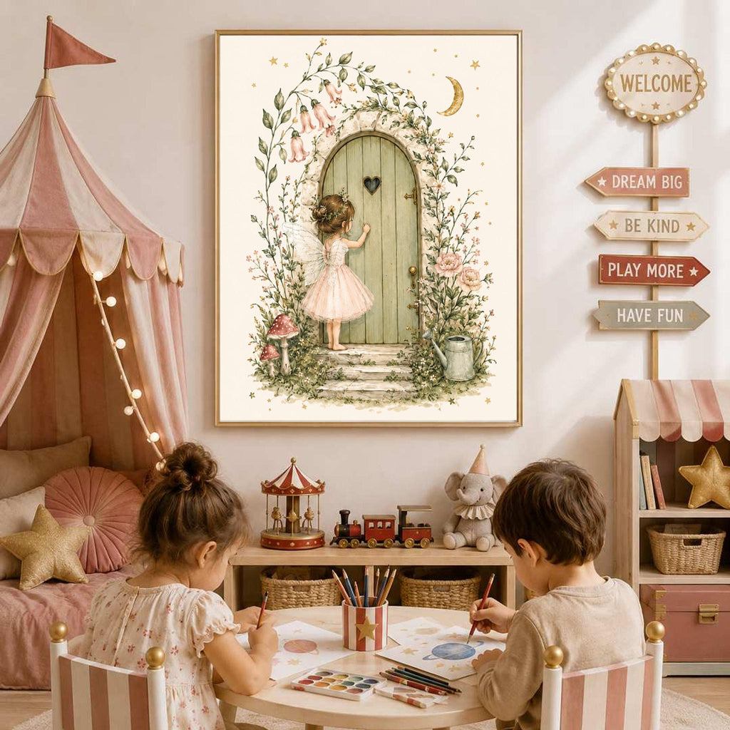 A framed watercolor illustration hangs on the wall above two children drawing at a small table, depicting a fairy knocking on a round wooden door surrounded by vines and flowers.