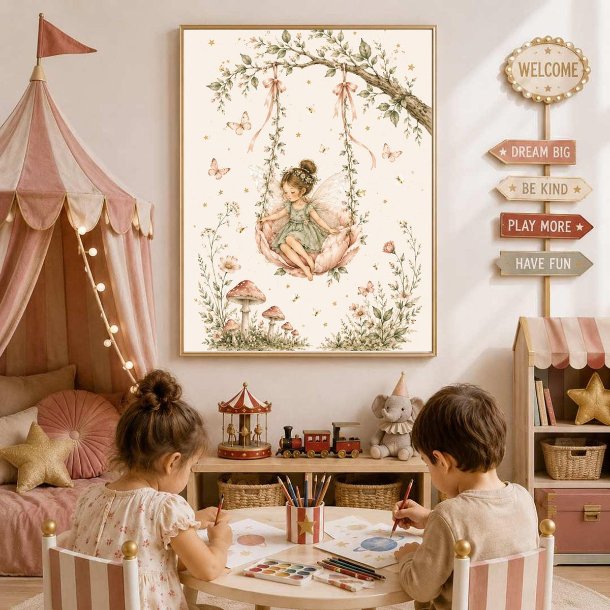 A framed watercolor painting of a fairy on a flower swing hangs on a wall above two children drawing at a small table in a brightly lit playroom.