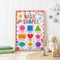 Colourful educational shapes wall print featuring smiling circle, square, triangle, rectangle, heart, star, oval, diamond and hexagon shapes with a rainbow, sun, flowers and playful decorations.