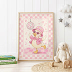 Pink disco duck children's wall print featuring a dancing duck wearing a floral pink hat, heart-shaped sunglasses and sparkly jacket beneath a disco ball, surrounded by musical notes and a soft pink checkerboard border.
