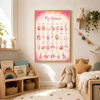 A framed pink alphabet print is mounted on a white wall above a low toy shelf and toddler bed.