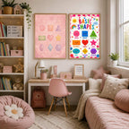 A pair of educational shapes posters are mounted on the wall above a child's desk and pink armchair.