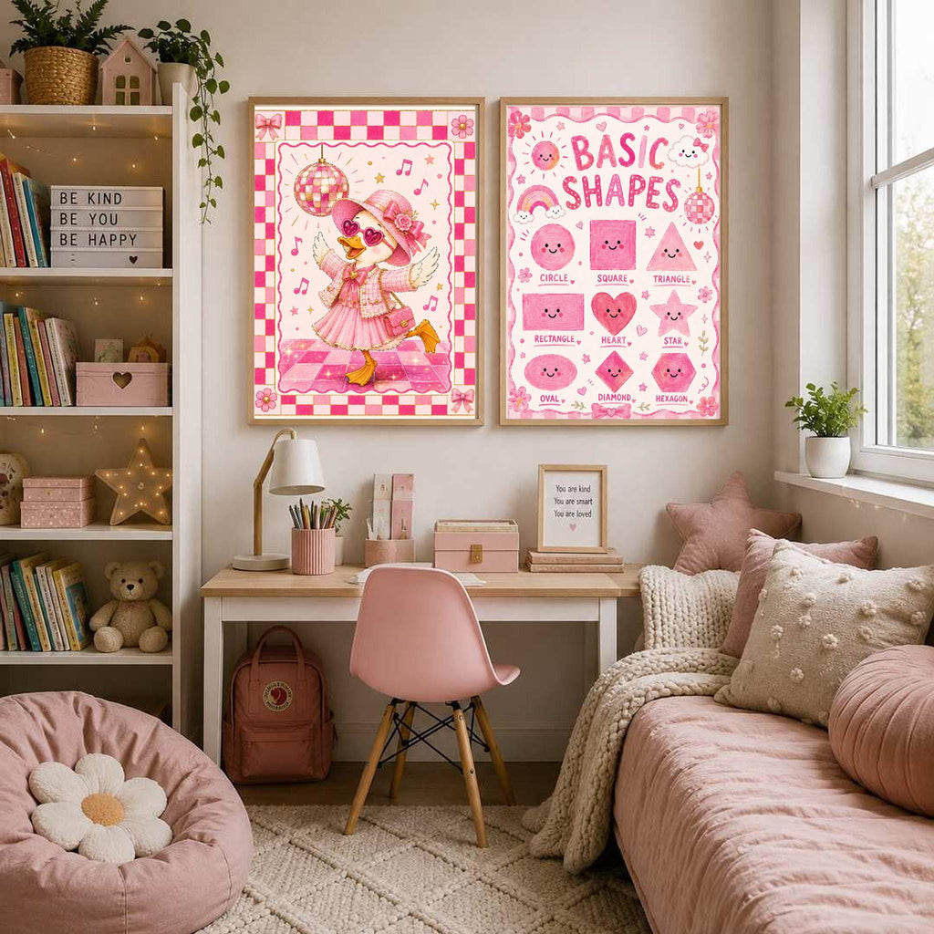 Two framed pink posters hang side by side on a wall above a desk and a pink bed in a child bedroom.