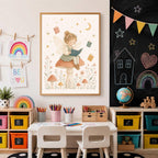 A framed fairy art print centered above a child art table with a chalkboard wall in the background.