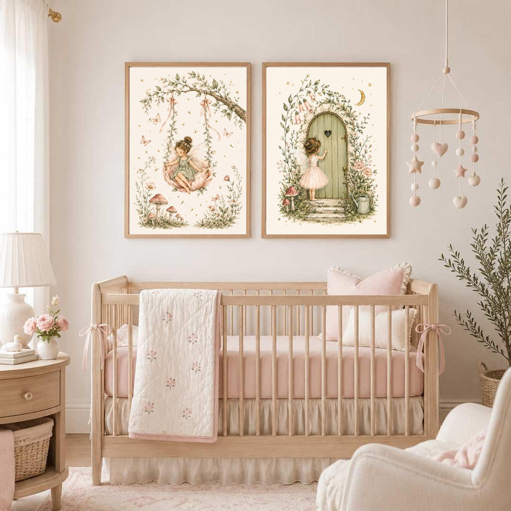 Two framed watercolor fairy prints hanging on the wall above a wooden crib in a nursery.